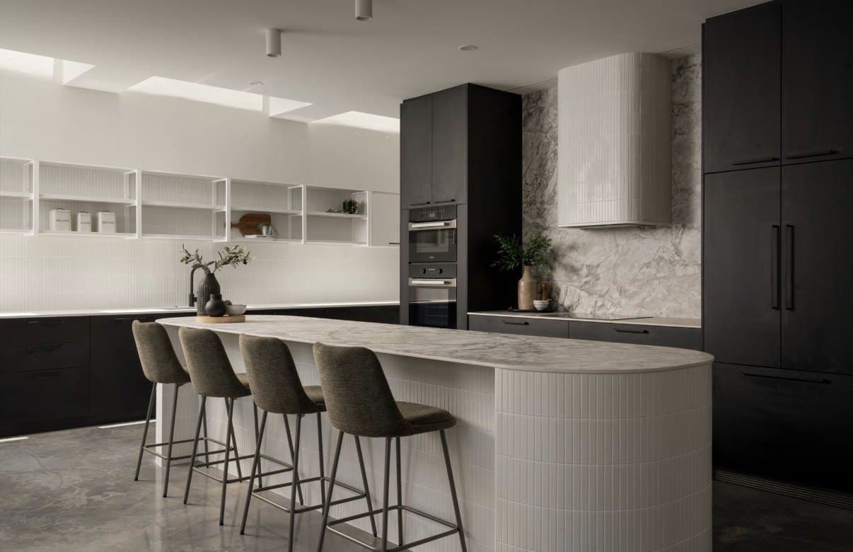 Curved kitchen island on a reflective polished concrete floor
