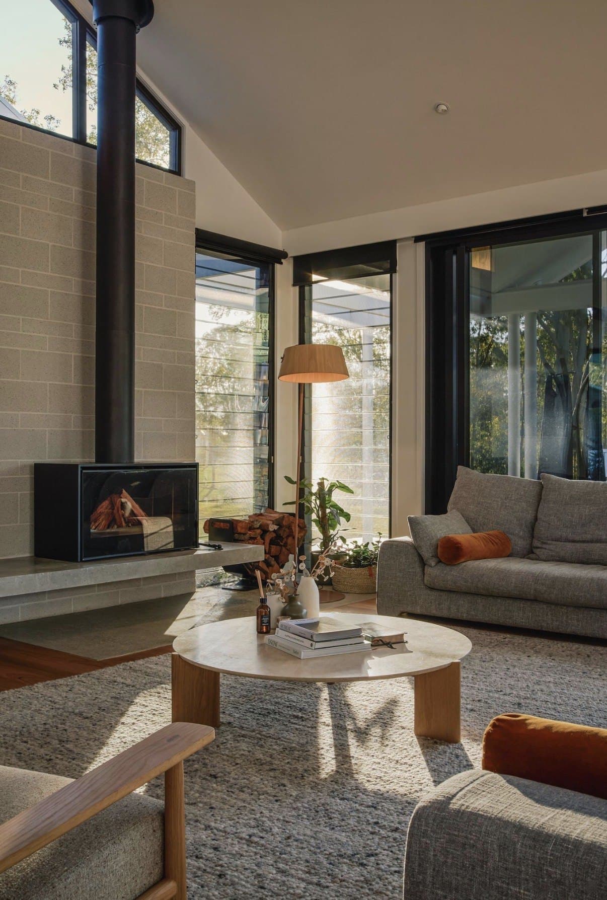 Living room with a concrete floor, fireplace and afternoon light