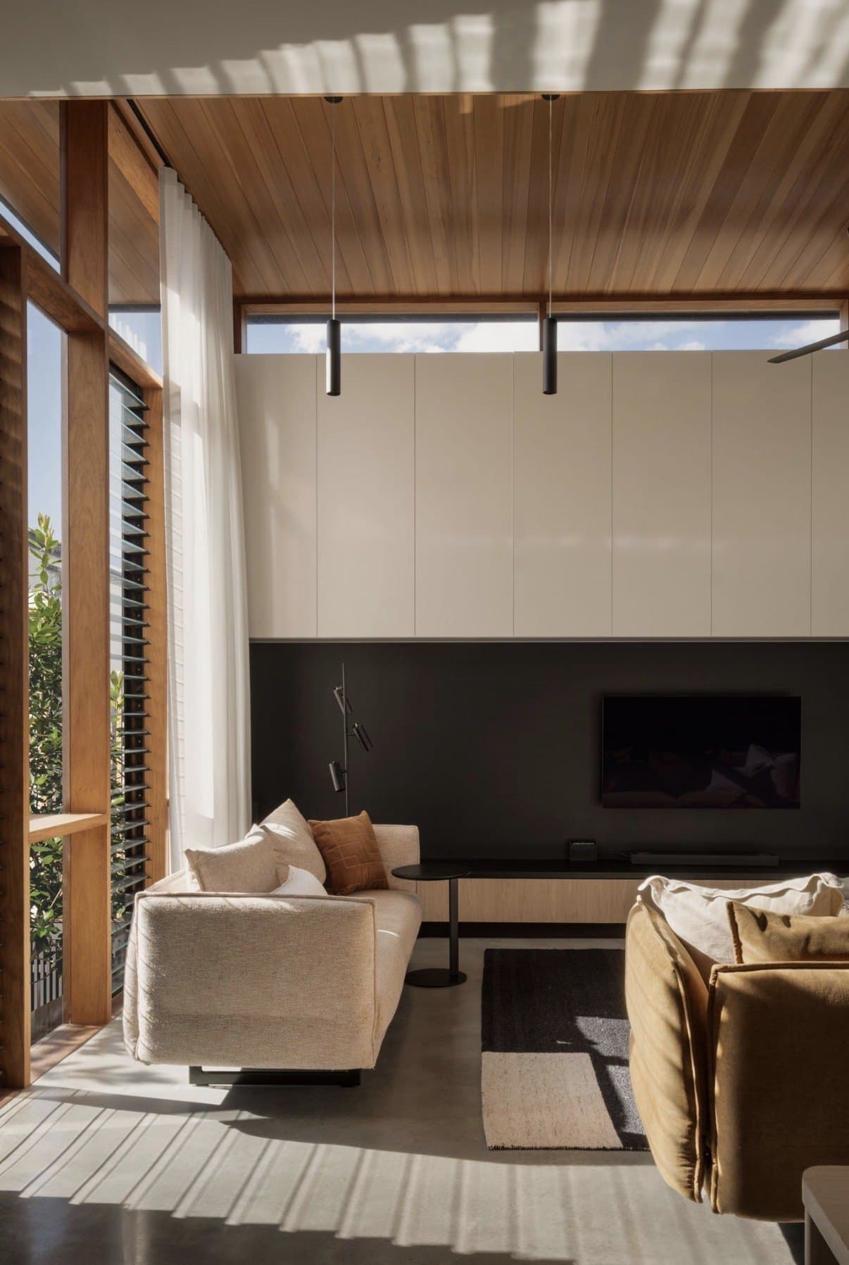 Living room with a polished concrete floor and long afternoon light