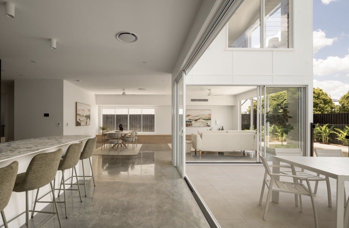 Open-plan kitchen and living area with a reflective concrete floor