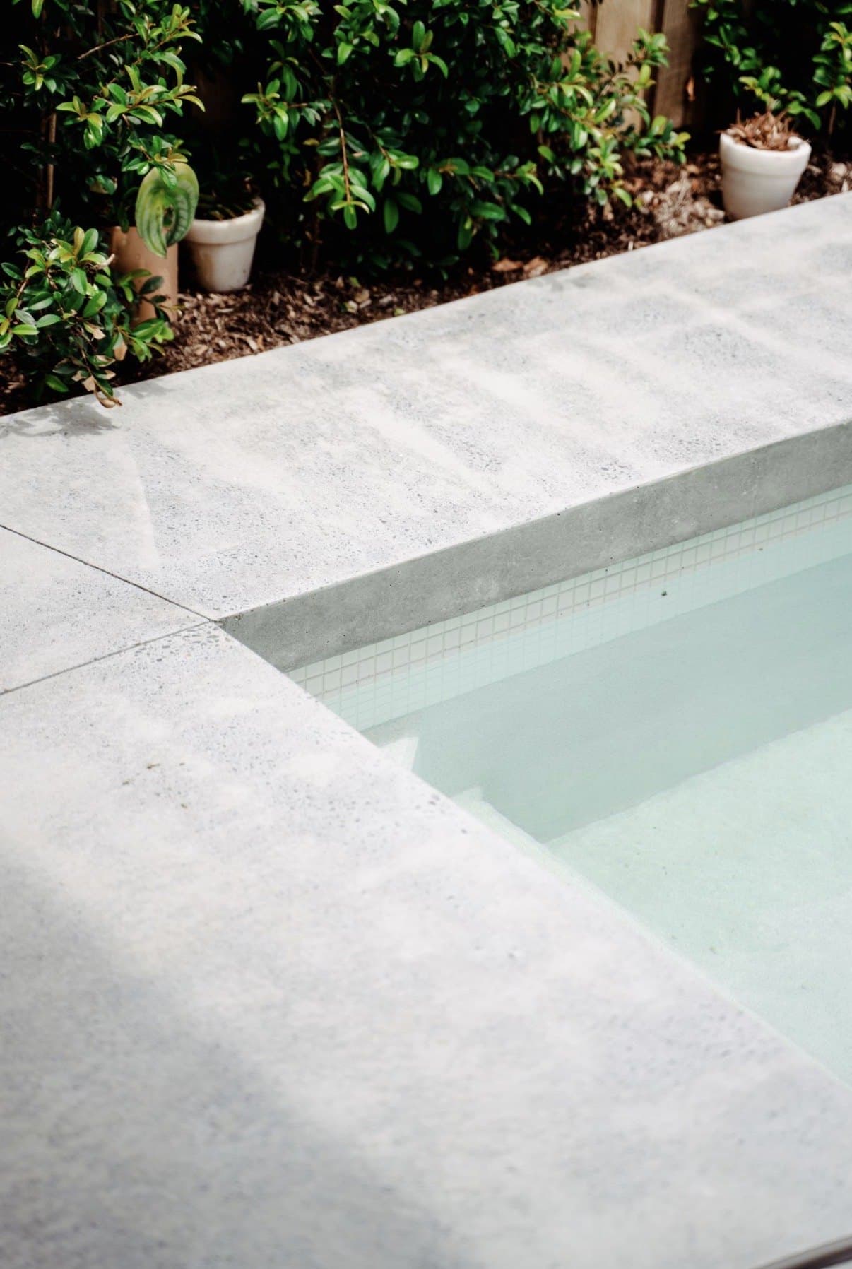 Honed concrete pool coping and surround in soft daylight